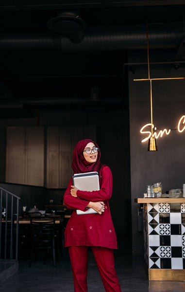 Hijab girl with laptop standing at cafe