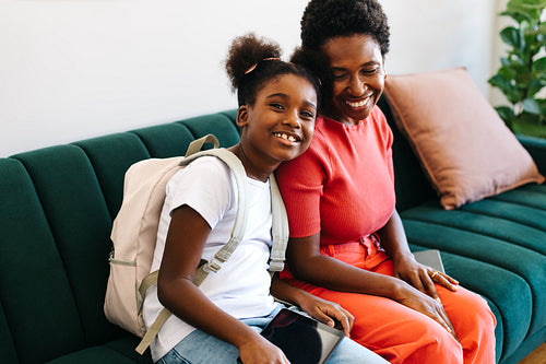 Happy mother and daughter ready for school in the morning