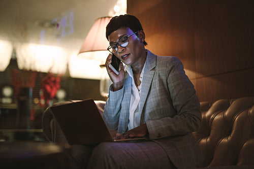 Mature businesswoman on trip working from hotel lobby