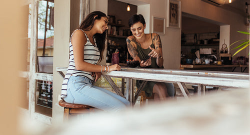 Women looking at mobile phone at home