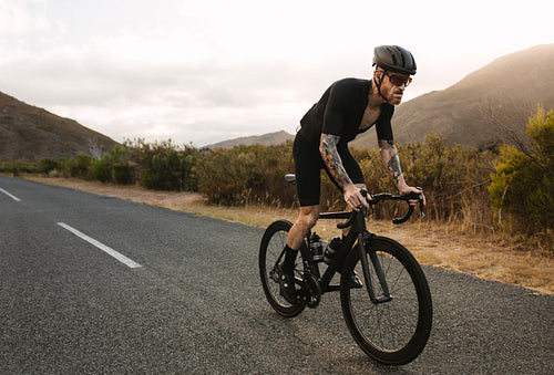Cyclist climbing up the hill on bike