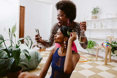 Friends celebrate at home with party in colorful outfits