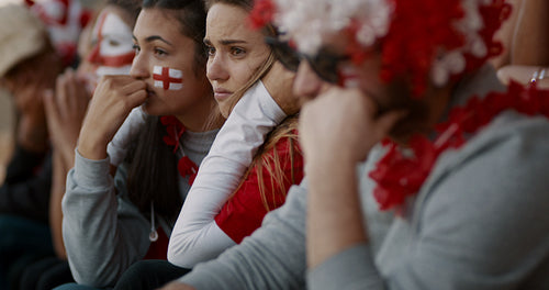 English football fans looking upset after defeat