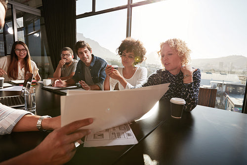 Man explaining business plan to colleagues