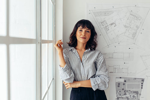 Portrait of female architect with her drawings