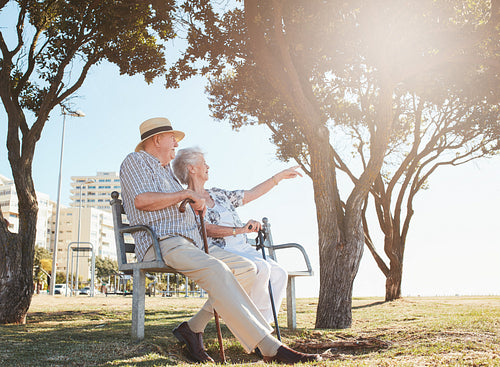 Retired couple taking a break and relaxing on a bench