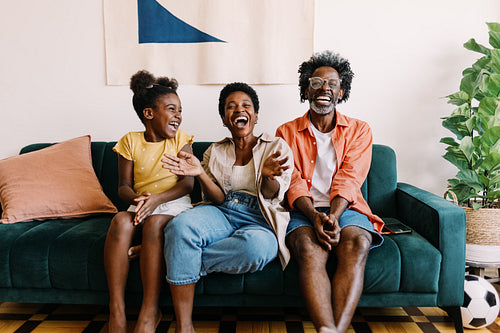 Happy family enjoying a football game together at home
