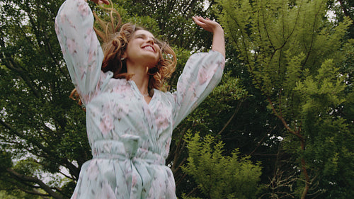 Cheerful woman dancing with joy