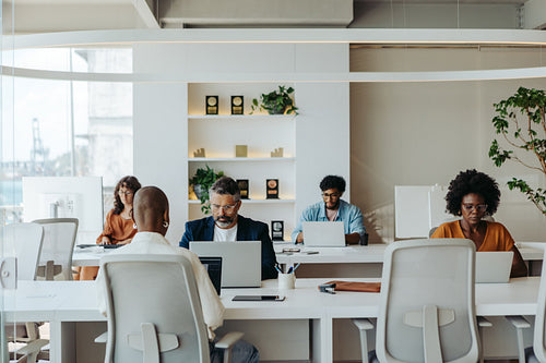 Diverse group of business professionals collaborating in a coworking office