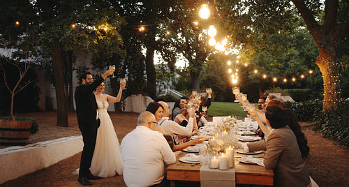 Elegant garden wedding celebration with family and friends under string lights