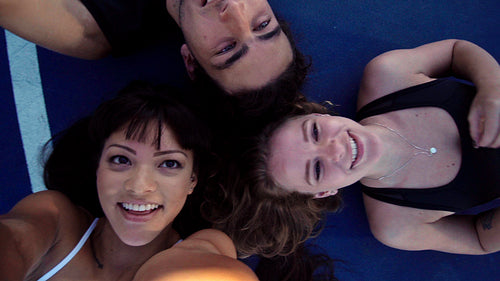 Top view of three happy friends taking a selfie together