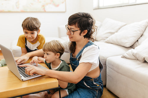 Young family using laptop at home