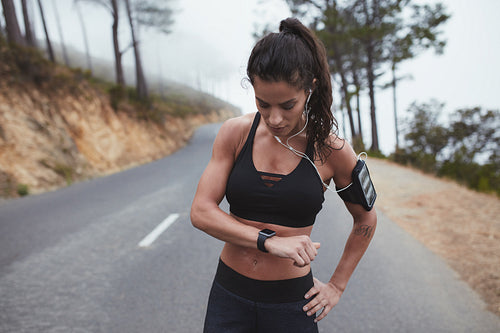 Fit woman monitoring her progress on smart watch