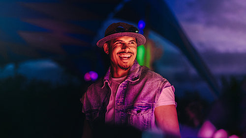 Dj celebrating nightlife in a vibrant festival atmosphere