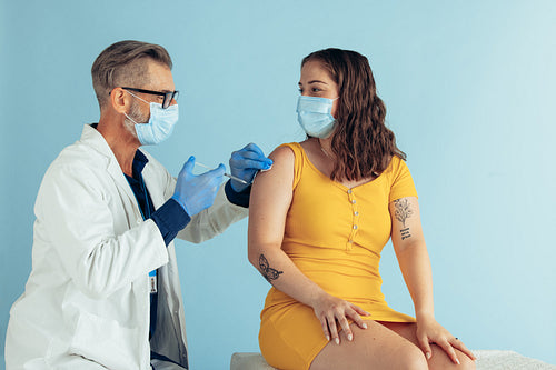 Doctor giving covid vaccine to woman