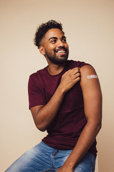 Man showing his shoulder after receiving a vaccine