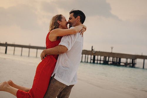 Sunset romance: Mature couple embracing in a romantic honeymoon moment