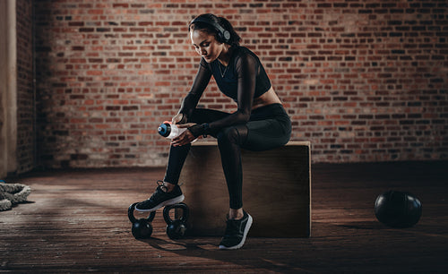 Woman relaxing after workout at gym
