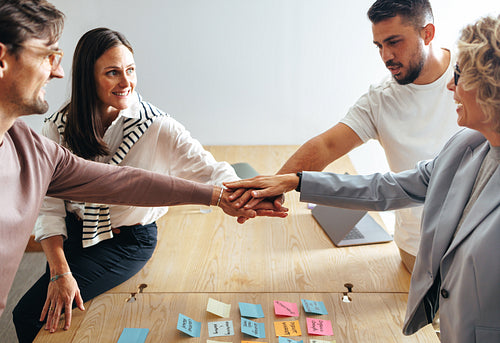 Creative business team putting their hands together in a stack