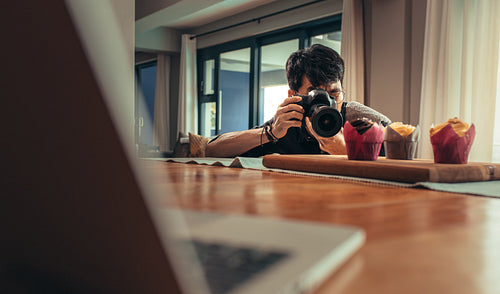 Food photographer shooting cupcakes in his studio
