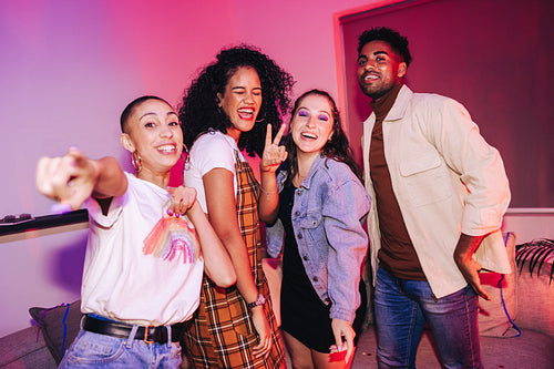 Four happy friends having a good time at a party