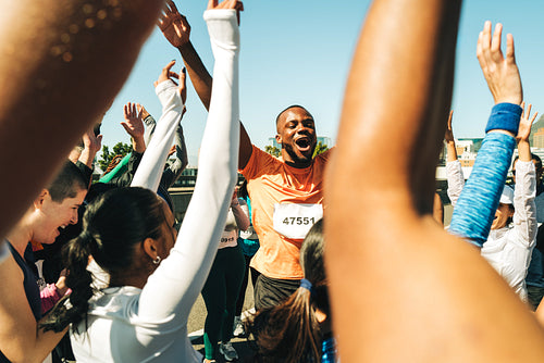 Marathon runners celebrating victory at the finish line
