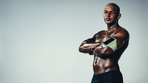 Fit male model standing with his arms crossed