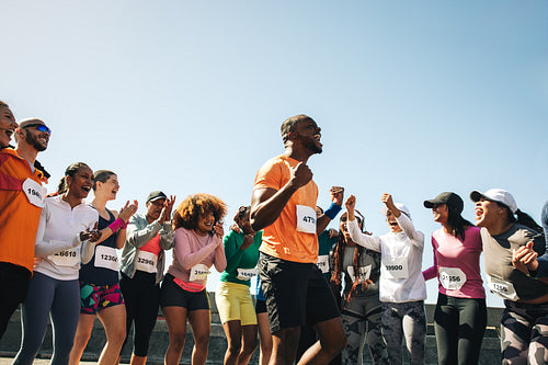 African male athlete celebrating after winning a competitive race