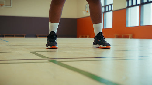 Basketball player dribbling on a court