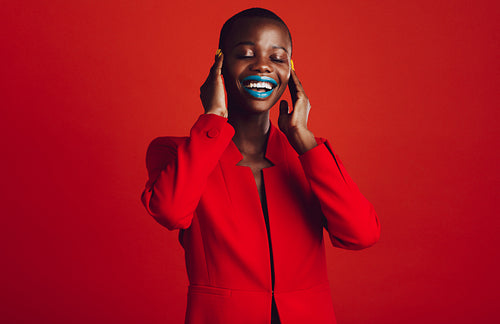Beautiful african woman covering her ears