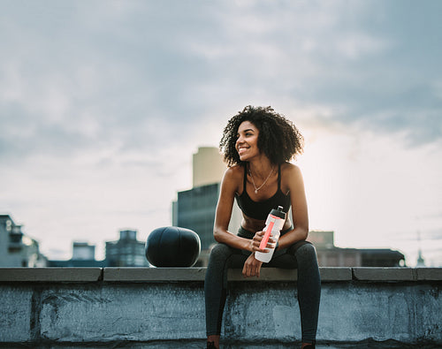 Fitness woman taking a break drinking water