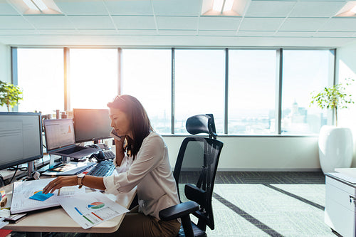 Businesswoman working at her desk in office.