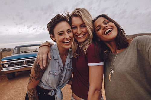 Young women taking self portrait on road trip