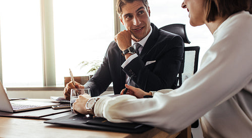 Happy corporate professionals discussing over new project