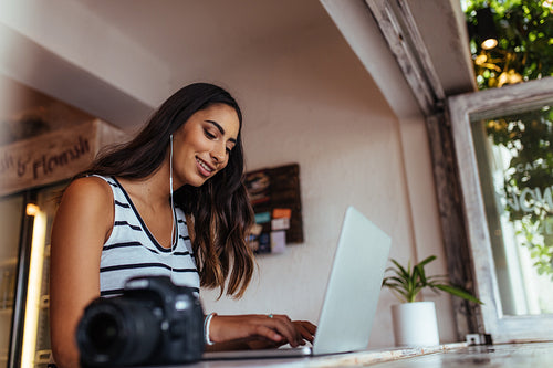Woman working on laptop computer at home