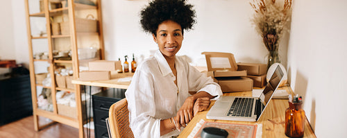 Jewelry artist at work desk with laptop