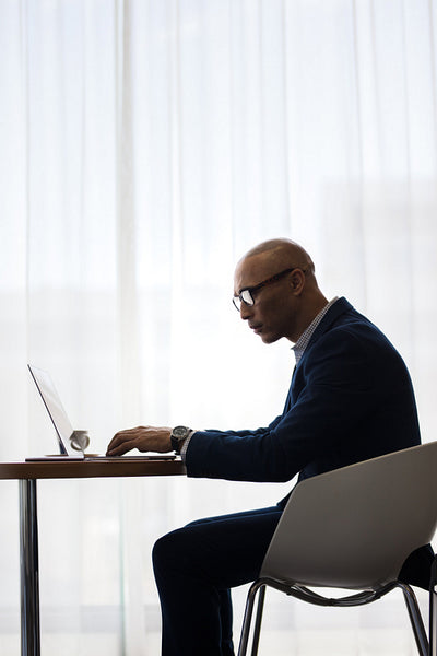 Businessman working on laptop computer in office