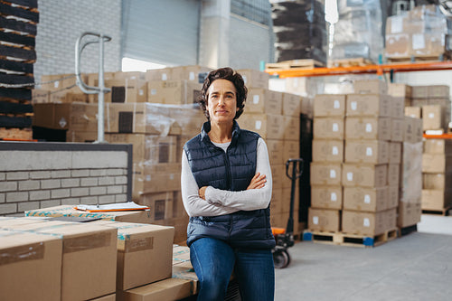 Warehouse supervisor looking at the camera in a logistics centre