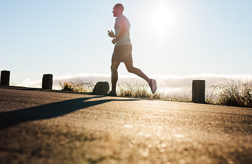 Man running on road in the morning