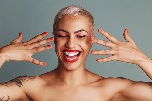 Excited female model showing her makeup