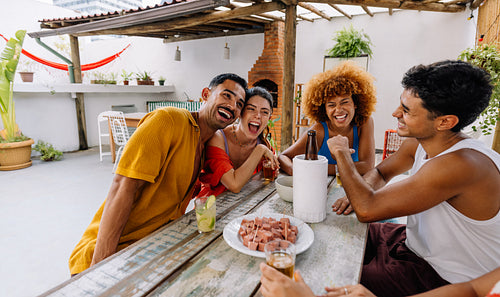 Friends gathering enjoying petiscos outdoors in Rio de Janeiro during a sunny day