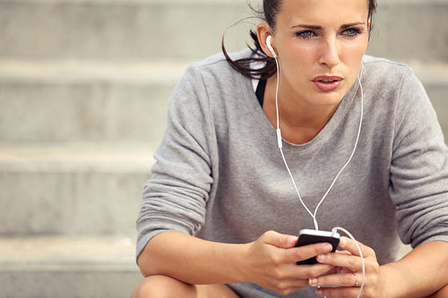 Serious Female Runner Listening to Music
