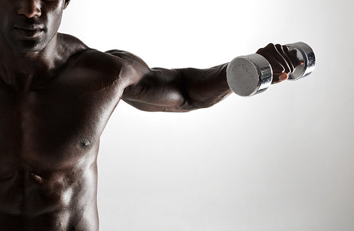 African fitness model working out with dumbbells