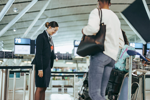 Airport attendant helping tourist family