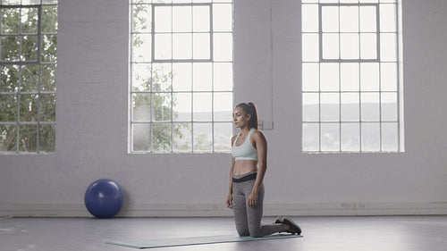 Woman doing plank climbers in fitness studio