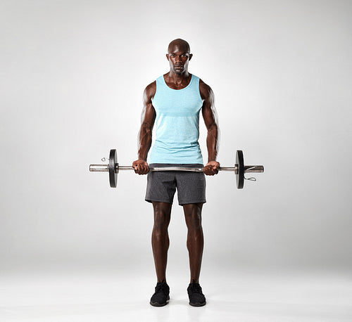 African male exercising with barbell