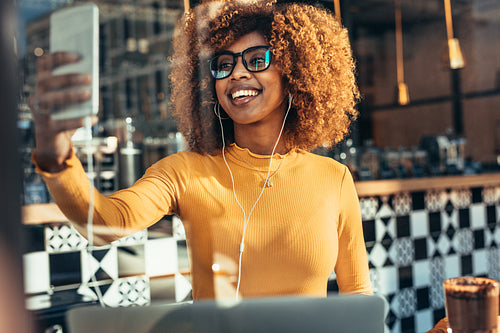 Smiling afro american woman taking a selfie