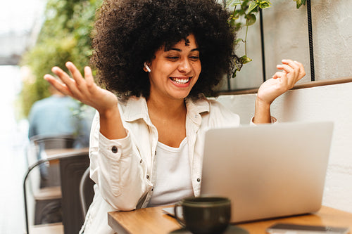 Freelancer and self-employed woman speaks on a video call in a cafe