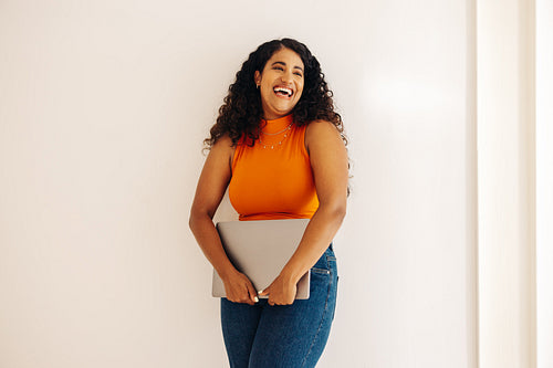 Young businesswoman laughing happily in an office
