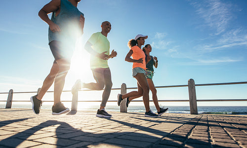 Young runners workout on the sea front path
